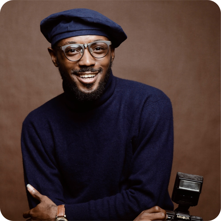 smiling man turtleneck beret glasses camera